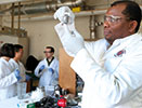 Iowa State University’s Martin Thuo holds a vial of the liquid-metal particles produced by his research group.